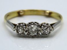 An antique 18ct gold ring set with three platinum