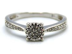 A 9ct white gold ring set with 0.15ct of diamonds,