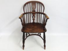 A 19thC. yew & elm Windsor arm chair with crinolin