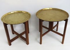 Two brass topped Benares tables with folding teak