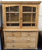 A 19thC. pine farmhouse dresser with glazed doors