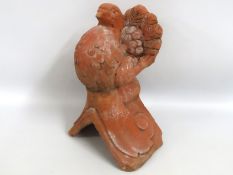 A terracotta style dove ridge tile, 390mm tall x 2