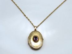 A 9ct gold 490mm long chain with 9ct locket set with amethyst, 35mm drop, 6.6g