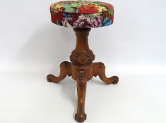 A Victorian carved walnut rise & fall music stool