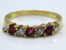 An 18ct gold half eternity ring set with four marq