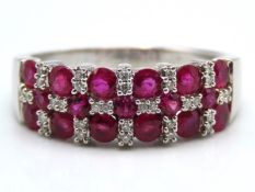 A white metal ring set with diamond & ruby, tests