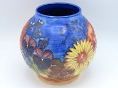 A Moorcroft pottery vase decorated with flowers &