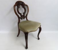 A 19thC. carved walnut dining chair with cabriole