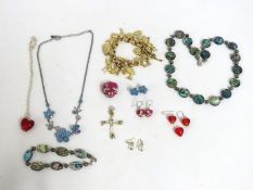 A gold plated charm bracelet twinned with other co