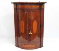 A George III mahogany corner cupboard with small d