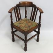 An Edwardian oak corner chair, 792mm high to back