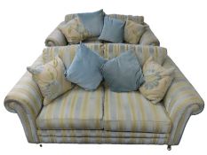 A pair of 21stC. sofas on legs with brass wheels t