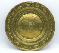 A 17thC. brass alms plate with repoussé decor, dep
