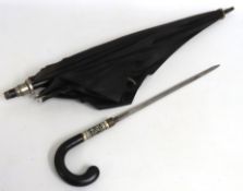 An Indian umbrella with concealed short sword, mat