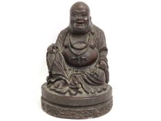 A Buddha figure, possibly a resin or ceramic, weig