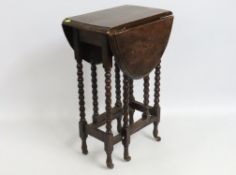 An antique oak drop leaf table with bobbin legs &