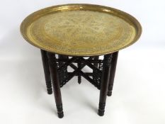 A brass Benares table with decorative base, 528mm