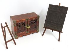 An Oriental cabinet, locked, twinned with a Chines