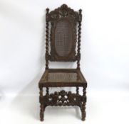 A well carved 19thC. cane chair, faults to cane, 1