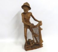 A carved wooden Oriental fisherman with net, 700mm