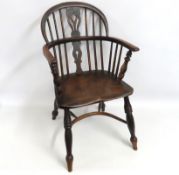 A 19thC. elm Windsor chair with crinoline stretche