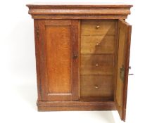 An antique oak cabinet set with eight well fitted