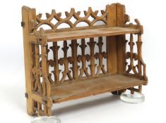 A 19thC. ecclesiastical Gothic pine folding shelf