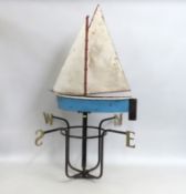 A large vintage weather vane depicting a sailboat,