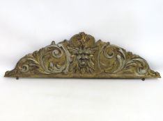 A carved giltwood green man frieze for back of cab