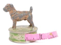 VINTAGE 20TH CENTURY PRESSED METAL TAPE MEASURE WITH DOG