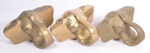 THREE BRASS ELEPHANT HEAD RAIL HOLDERS
