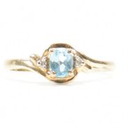 9CT GOLD TOPAZ & DIAMOND CROSSOVER RING