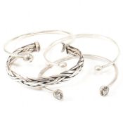 FOUR SILVER TORQUE BRACELETS