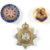 COLLECTION OF WHITE METAL POLICING BADGES & ABALONE BADGE