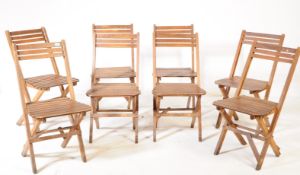EIGHT VINTAGE TEAK FOLDING SLATTED DINING CHAIRS