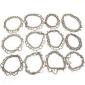 COLLECTION OF THIRTEEN INDIAN WHITE TONE METAL CHAIN ANKLETS