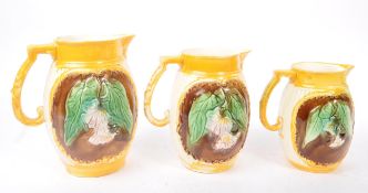 COLLECTION OF THREE GRADUATING VICTORIAN MAJOLICA JUGS