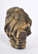20TH CENTURY BRASS SKULL VESTA CASE WITH OCTOPUS