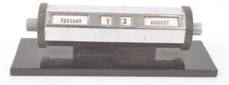 1930S METAL PERPETUAL DESKTOP CALENDAR ON BAKELITE BASE