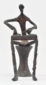BRONZE FIGURE OF A MUSICIAN PLAYING PERCUSSION INSTRUMENT