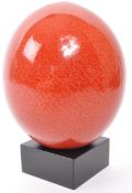 20TH CENTURY SANGUINE COLOUR OSTRICH EGG ON STAND