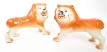 PAIR OF 19TH CENTURY CERAMIC POTTERY FIRESIDE LIONS
