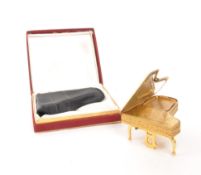 PYGMALION - 1950S GILT METAL MUSICAL PIANO COMPACT CASE