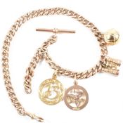 An early 20th century 9ct rose gold watch chain with 9ct and 18ct gold charms. The watch chain