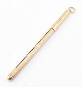 A hallmarked 9ct gold champagne swizzle stick. The vintage cocktail stirrer stick having an engine