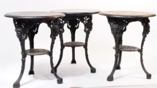 THREE EARLY 20TH CENTURY CAST IRON PUB TABLES