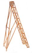 EARLY 20TH CENTURY LATTICE WORKED WOODEN LADDER