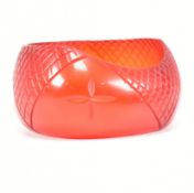 VINTAGE RED CARVED LUCITE BANGLE