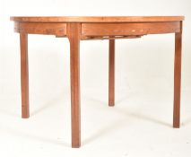 NILS JONSSON, SWEDEN - MID CENTURY TEAK EXTENDING CIRCULAR DINING TABLE