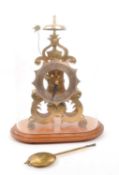 SKELETON CLOCK SET IN OVAL GLASS DOME